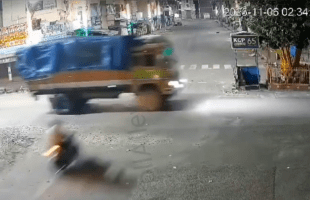 Man On Motorbike Meets Big Truck