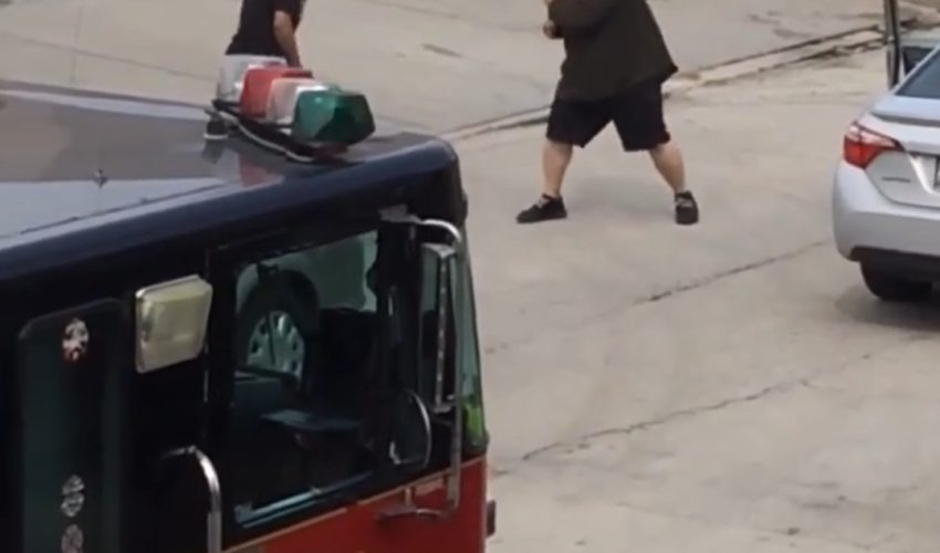 Two Men Seen Going At It In Chicago In Front Of A Fire Truck