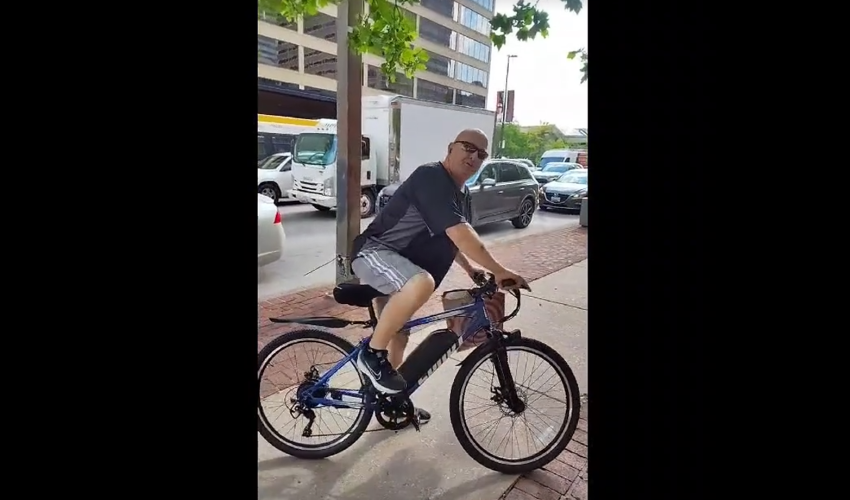 Man On A Bike Got Mad And Tried To Attack A Black Woman For Protesting About FBI Director Kash Patel And Kid Safety