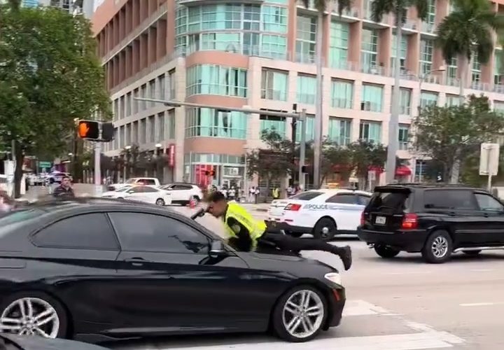 Miami Police Officer Missed At Close Range After Dude Drove Off With Him On The Hood Of His Car