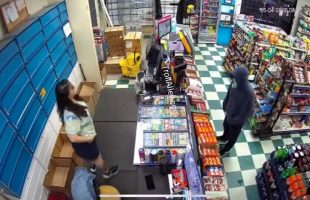 Man With A Gun Runs After Store Clerk Reach For Something Behind The Store Counter