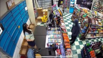 Man With A Gun Runs After Store Clerk Reach For Something Behind The Store Counter
