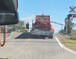 Semi Truck Driver Didn’t Want To Back Up Or Go Forward Because He Got Stuck On The Crossing Bars So He Let The Train Go Thru His Truck