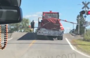 Semi Truck Driver Didn’t Want To Back Up Or Go Forward Because He Got Stuck On The Crossing Bars So He Let The Train Go Thru His Truck
