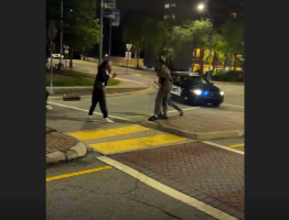 Police Sits In His Car While Two Men Throw Hands Right In Front Of Him