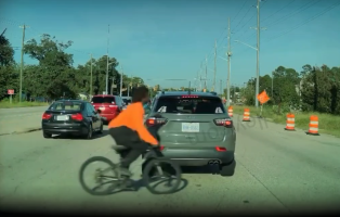 Man Caught This On His Dashcam After A Man Tried To Cross The Street With His Bike